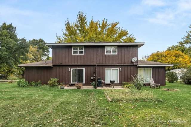 a view of a house with a yard and plants