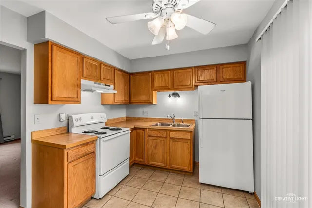 a kitchen with stainless steel appliances granite countertop a refrigerator sink and cabinets