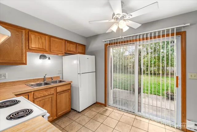 a kitchen with a refrigerator a stove a sink dishwasher and cabinets
