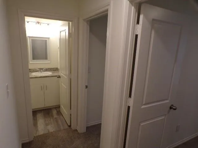 a view of a bathroom from a hallway