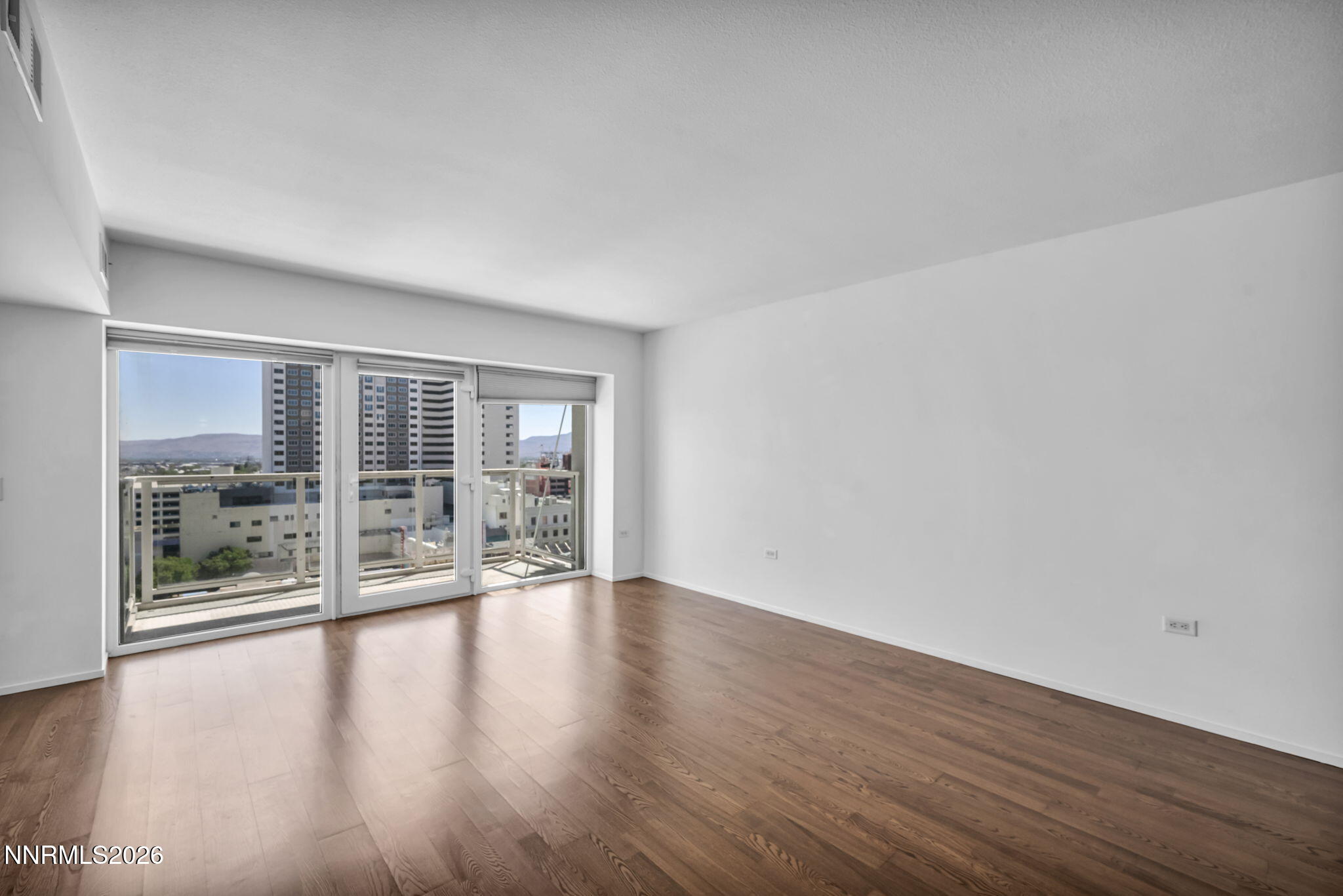 255 North Sierra Street, Unit 1208 Reno, NV 89501 - Photo 6 of 37 a view of an empty room with wooden floor and a window