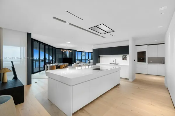a view of kitchen with sink and refrigerator
