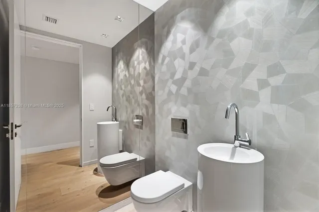 a bathroom with a toilet a sink and mirror