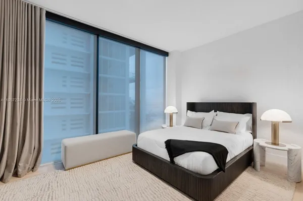 a bedroom with a bed and a couch