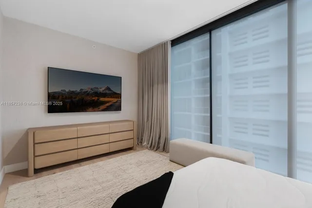 a bedroom with a bed and a television