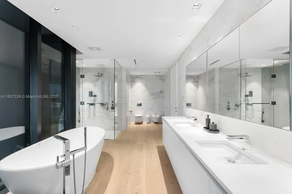 a bathroom with a bathtub shower sink and toilet