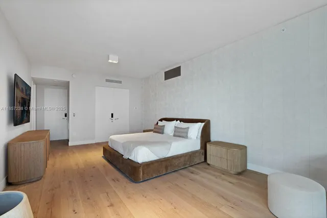 a spacious bedroom with a bed and a couch