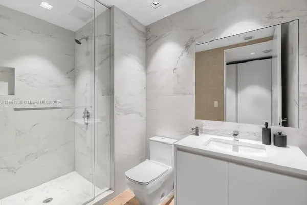 a bathroom with a sink toilet and shower