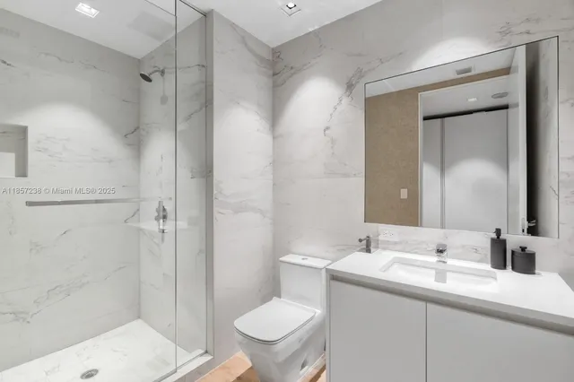 a bathroom with a sink toilet and shower