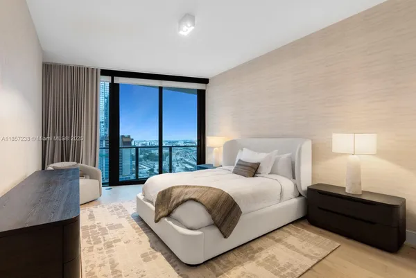 a bedroom with a bed and a large window