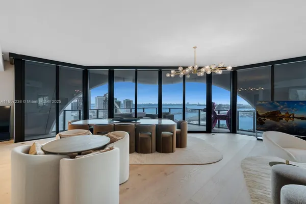 a dining room with furniture and a floor to ceiling window