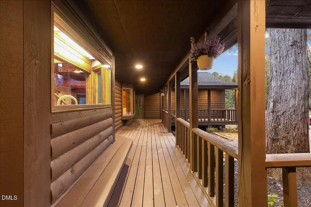 a view of a house with backyard and wooden fence