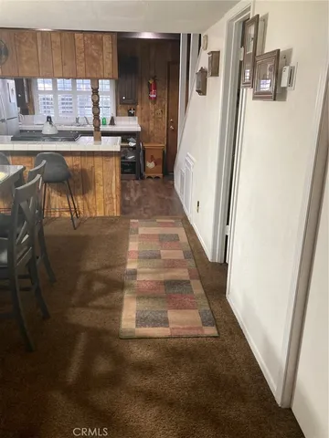 a kitchen with granite countertop a refrigerator and a sink