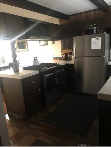 a kitchen with a sink a refrigerator and window