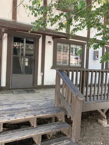 a view of a house with a wooden deck
