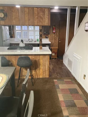 a kitchen with granite countertop sink and cabinets