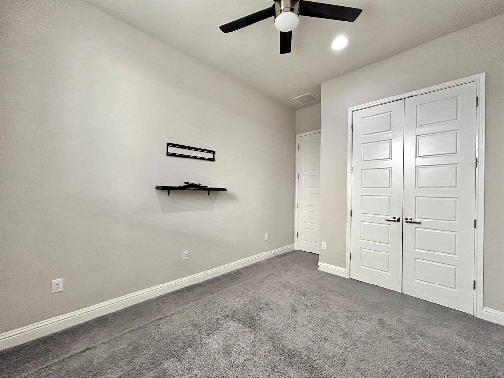 9313 Kyles Stake Road Austin, TX 78717 - Photo 23 of 40 Unfurnished bedroom with carpet floors, a closet, and a ceiling fan