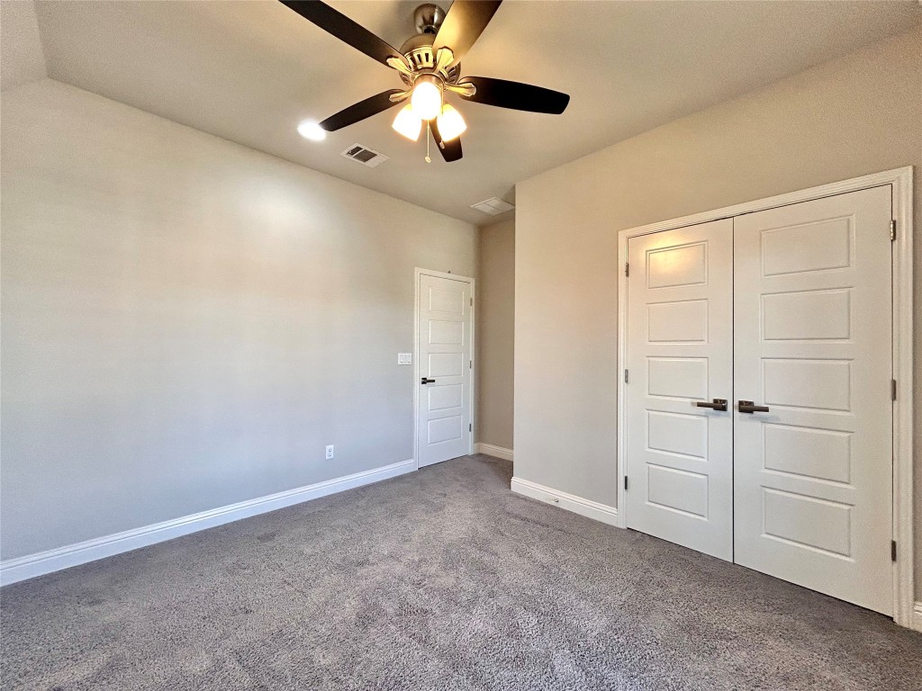 9313 Kyles Stake Road Austin, TX 78717 - Photo 28 of 40 Unfurnished bedroom featuring carpet floors, a closet, and ceiling fan