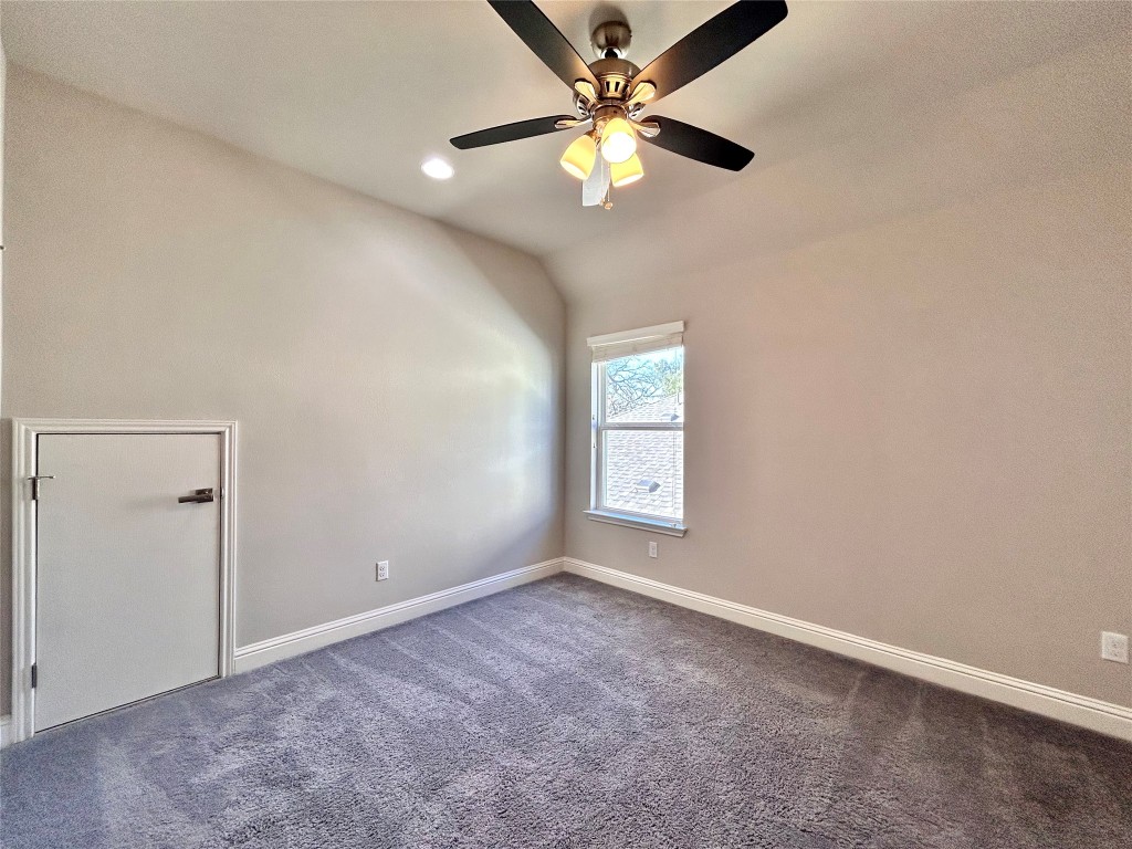 9313 Kyles Stake Road Austin, TX 78717 - Photo 32 of 40 Empty room with dark colored carpet, recessed lighting, ceiling fan, and lofted ceiling