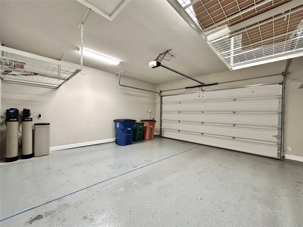 9313 Kyles Stake Road Austin, TX 78717 - Photo 36 of 40 Garage featuring baseboards