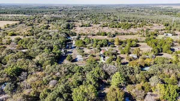 an aerial view of a houses with a yard
