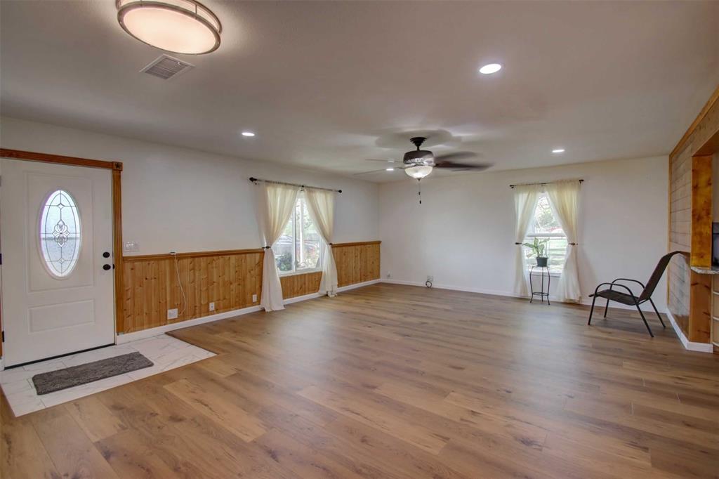3559 Springfield Road Springtown, TX 76082 - Photo 3 of 37 a view of empty room with wooden floor and fan