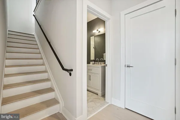 a view of a hallway with wooden floor and entryway