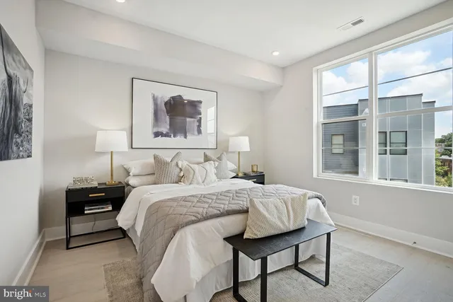 a bedroom with a bed and a window