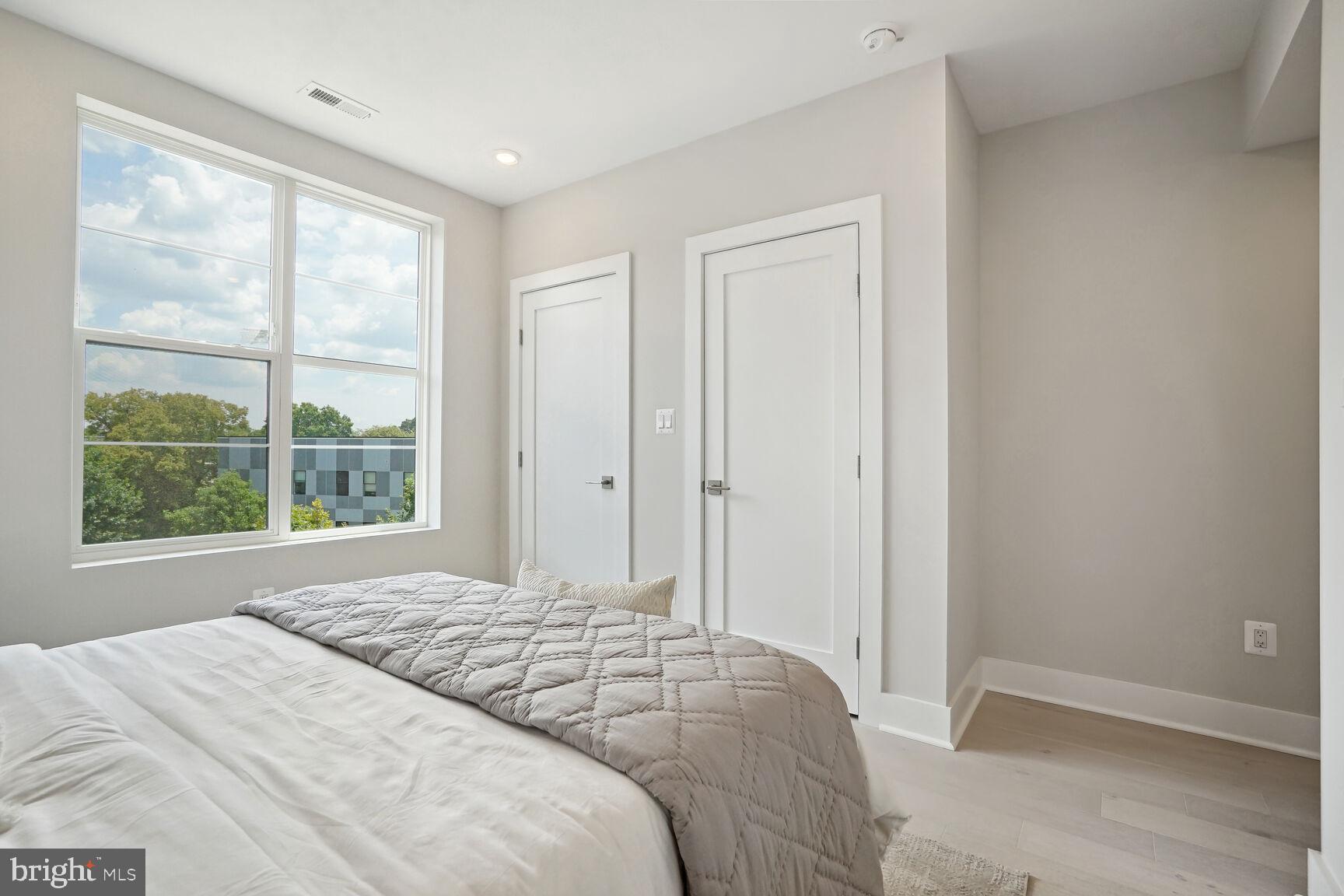 901 19th Street Northeast, Unit PH2 Washington, DC 20002 - Photo 13 of 31 a bedroom with a bed and a window