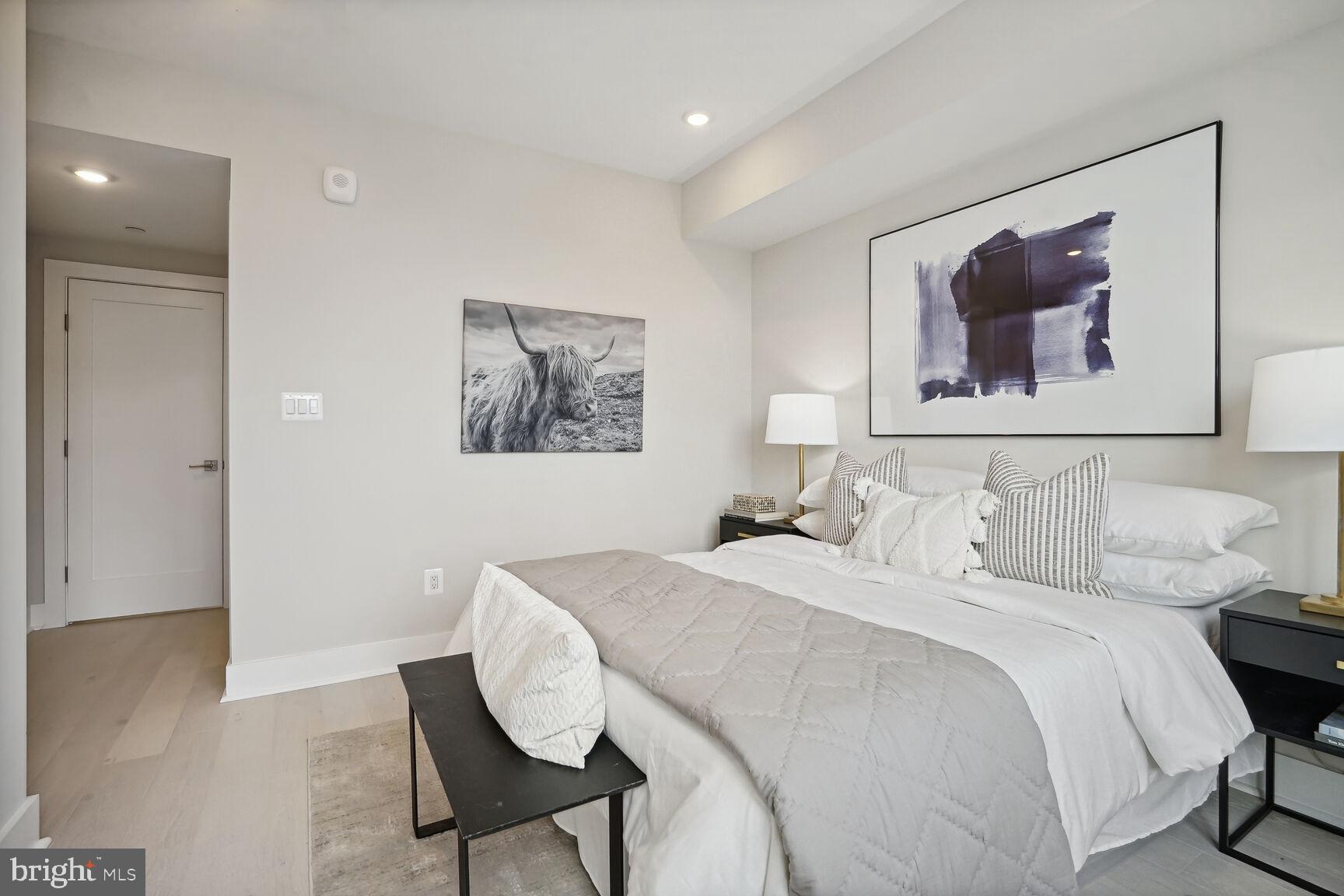 901 19th Street Northeast, Unit PH2 Washington, DC 20002 - Photo 14 of 31 a bedroom with a bed and wooden floor