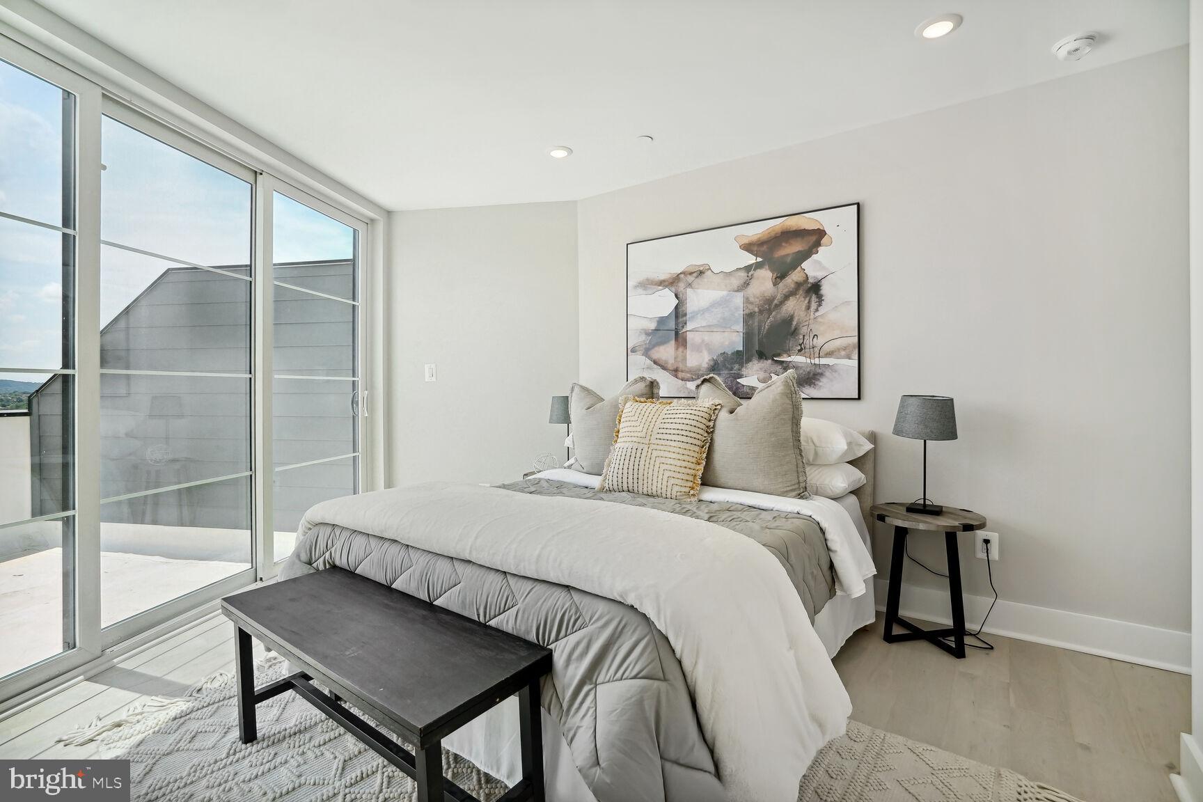 901 19th Street Northeast, Unit PH2 Washington, DC 20002 - Photo 15 of 31 a bedroom with a bed and wooden floor