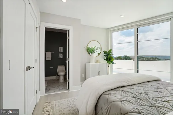 a bedroom with a bed and a large window