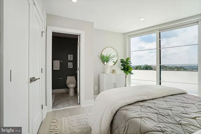 a bedroom with a bed and a large window