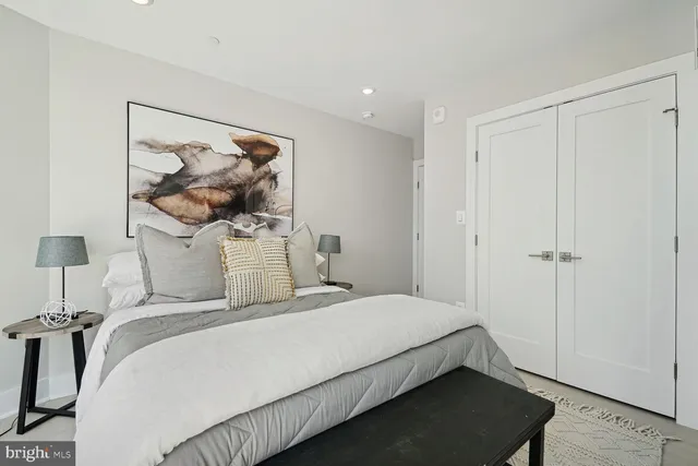 a bedroom with a bed and a lamp on table