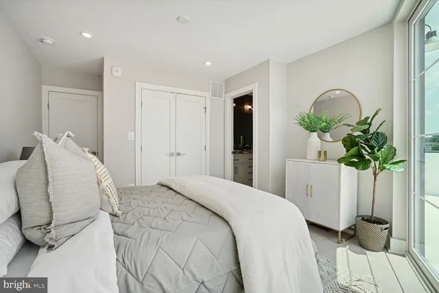 a bedroom with a bed and a potted plant