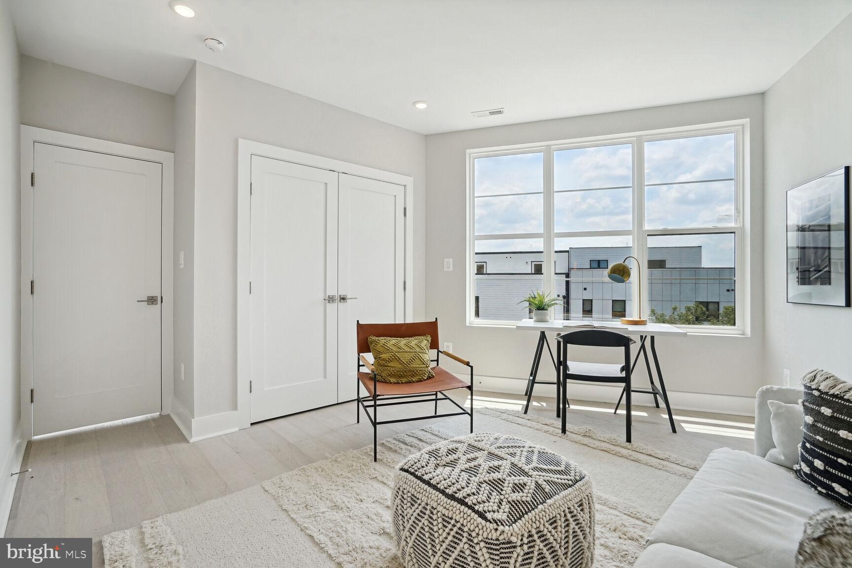 901 19th Street Northeast, Unit PH2 Washington, DC 20002 - Photo 20 of 31 a living room with furniture and a window