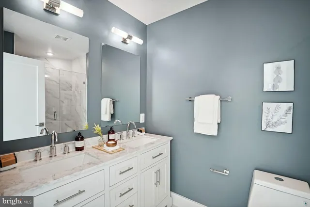 a bathroom with a sink double vanity and a mirror