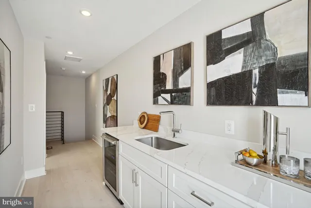a kitchen with a sink a stove and a refrigerator