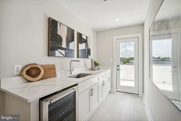 a kitchen with a refrigerator and a stove top oven