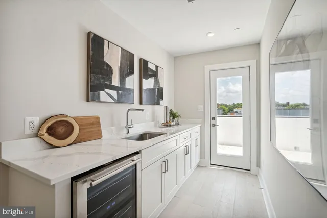 a kitchen with a refrigerator and a stove top oven