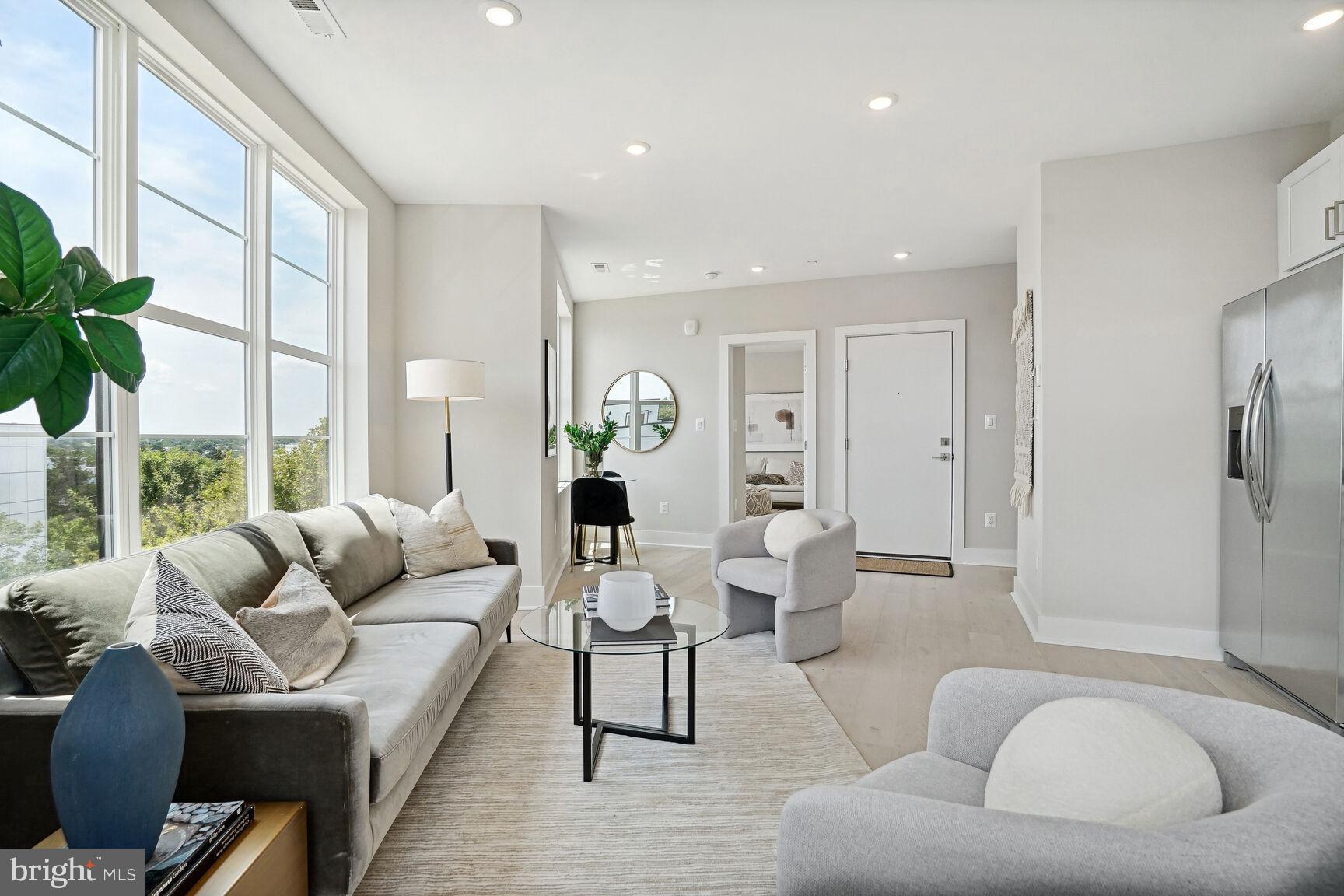 901 19th Street Northeast, Unit PH2 Washington, DC 20002 - Photo 4 of 31 a living room with furniture and a large window