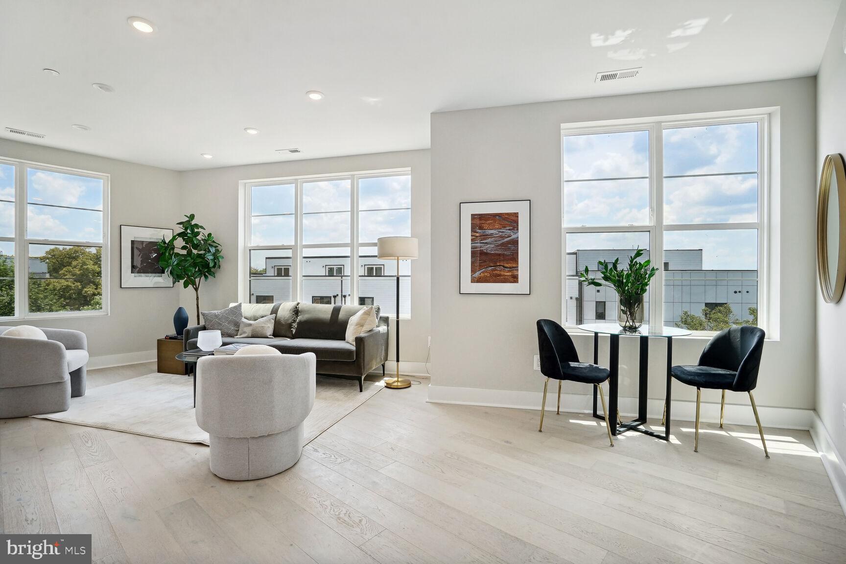 901 19th Street Northeast, Unit PH2 Washington, DC 20002 - Photo 5 of 31 a living room with fireplace furniture and a large window