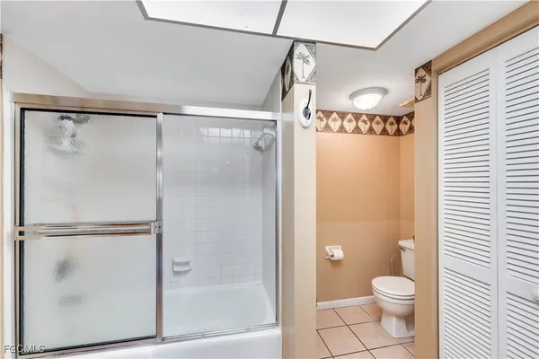 a bathroom with a granite countertop shower toilet and sink
