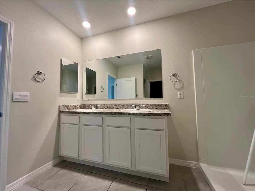 531 Auburn Grove Terrace Auburndale, FL 33823 - Photo 15 of 26 a bathroom with a granite countertop sink and a mirror
