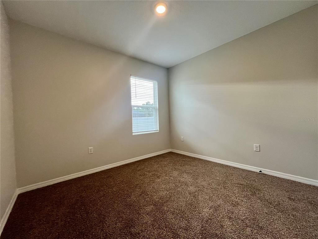 531 Auburn Grove Terrace Auburndale, FL 33823 - Photo 22 of 26 an empty room with windows