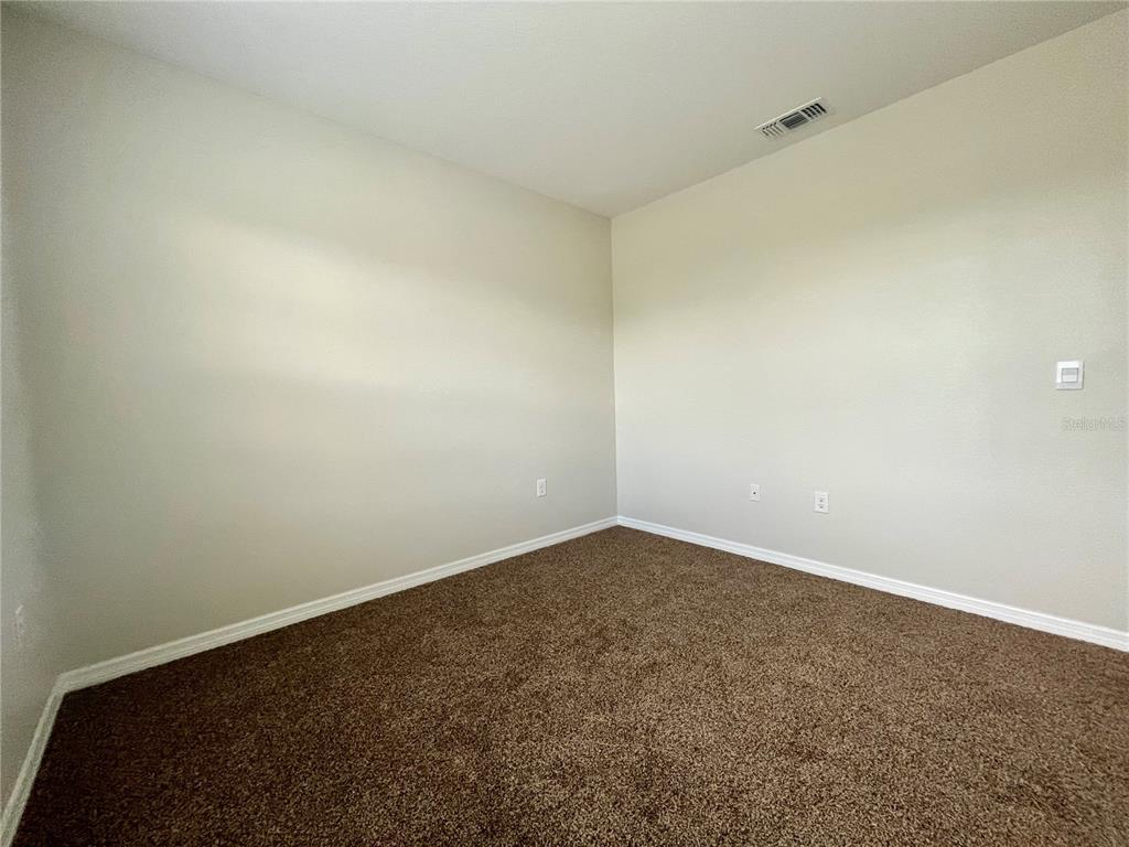 531 Auburn Grove Terrace Auburndale, FL 33823 - Photo 23 of 26 an empty room with a workbench