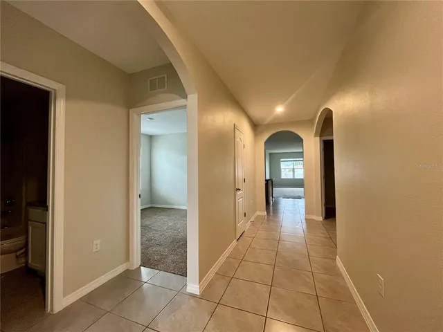 a view of a hallway view with staircase