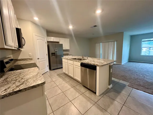 a kitchen with a stove sink and refrigerator