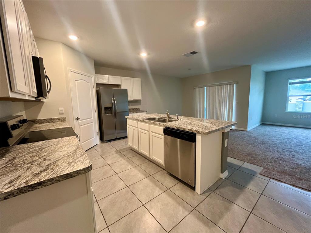 531 Auburn Grove Terrace Auburndale, FL 33823 - Photo 10 of 26 a kitchen with a stove sink and refrigerator