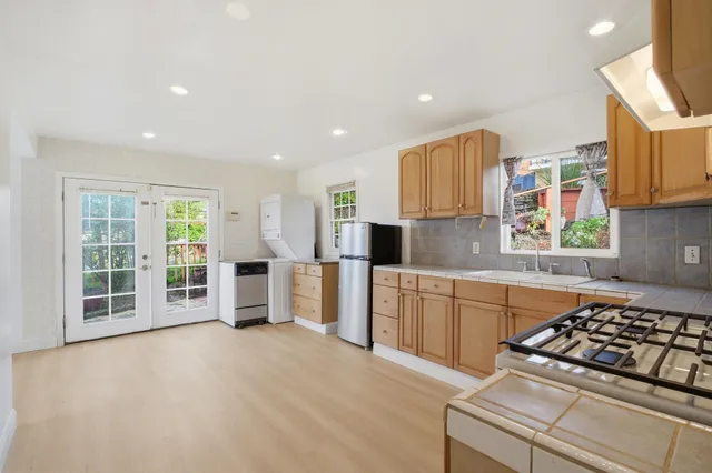 a kitchen with stainless steel appliances granite countertop a stove and a refrigerator